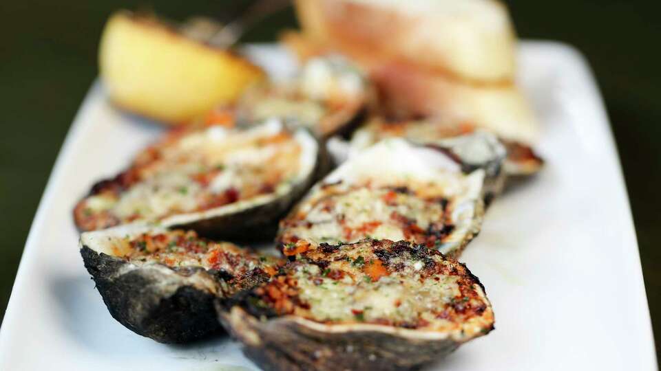 The loaded chargrilled oysters with applewood bacon and habaneros are seen at Good Charlie's Oyster Bar and Seafood Kitchen, Tuesday, Aug. 8, 2023, in Conroe.