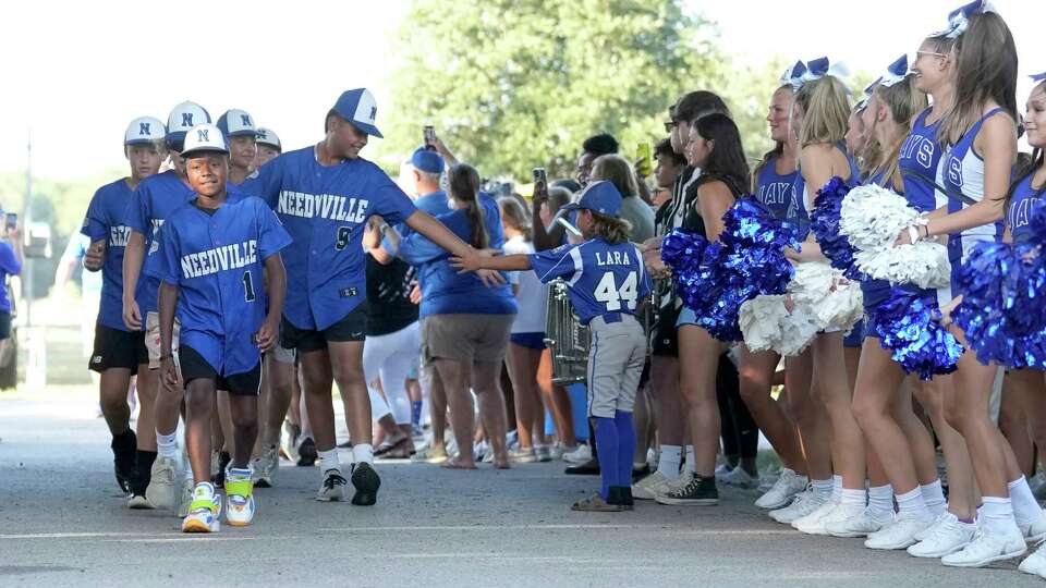 Jakolby White (1) leads his team through a parade during a pep rally for the Needville Little League team at Harvest Park as they prepared to head to the Little League World Series on Wednesday, Aug. 9, 2023 in Needville.