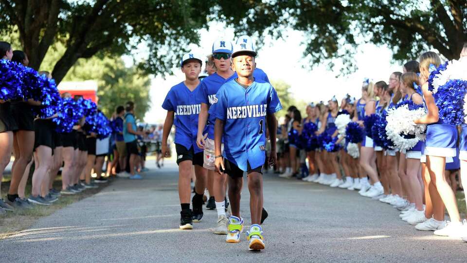 Jakolby White (1) leads his team through a parade during a pep rally for the Needville Little League team at Harvest Park as they prepared to head to the Little League World Series on Wednesday, Aug. 9, 2023 in Needville.