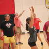 Reed City volleyball coach Don Patterson (left) supervises a practice during the summer season.
