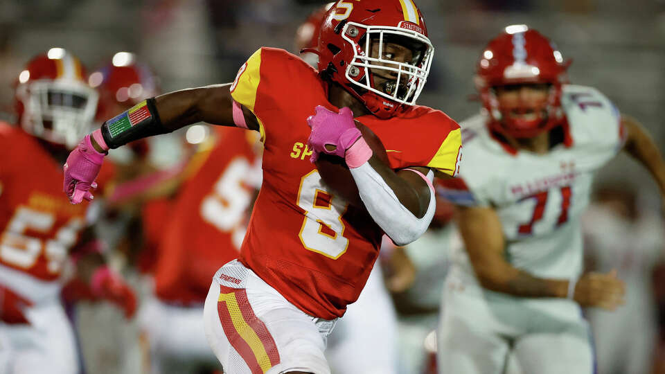 Stafford Spartans Jamaal Wiley (8) runs past the tackle by Brazosport Exporters Darius Roberson (0) during the high school football game between the Stafford Spartans and the Brazosport Exporters at Stafford Municipal Stadium in Stafford, TX on Friday, October 14, 2022. Stafford defeated Brazosport 14-7.