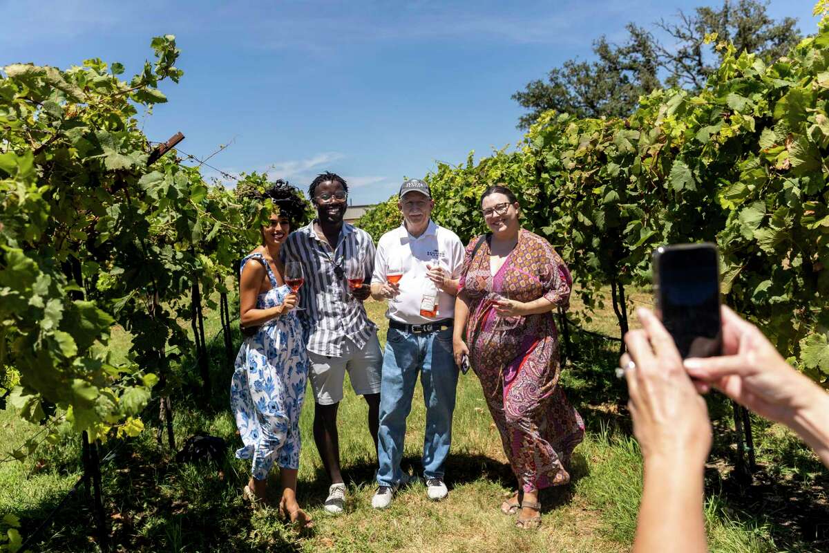 From left:, Jessica Serna; Ismail Mpiana; Dr. Bob Young, co-owner and winemaker at Bending Branch Winery; and Haley Plotkin gather in the winery’s vineyard in Comfort.