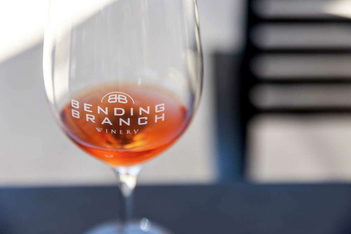 Branch Tannat Frizzante Rosé is seen in a Bending Branch branded wine glass at the winery in Comfort.