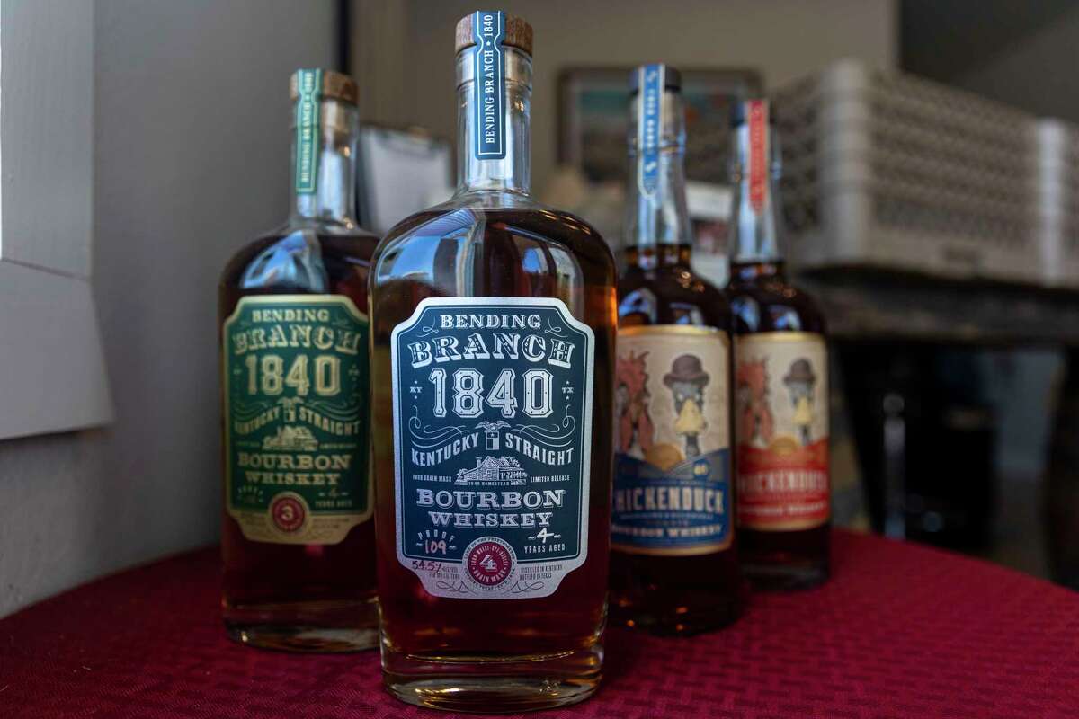 Bottles of the recently launched Bending Branch 1840 line of bourbons, including a premium high rye and a four-grain mash bill bourbon, and a sustainably minded ChickenDuck line are displayed at Bending Branch Winery in Comfort.