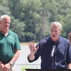 Swmmer Lewis Pugh, center speaks near the Corning Preserve Boat Launch Friday, Aug. 11, 2023 in Albany. State commissioner of Parks, Recreation and Historic Preservation Erik Kulleseid, left, looks on.
