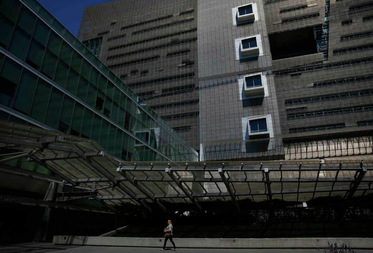 A pedestrian walks past the plaza outside the Speaker Nancy Pelosi Federal Building at Seventh and Market streets in San Francisco.