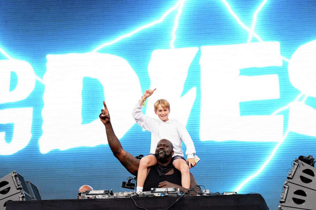 DJ Diesel performs while a festival attendee rides on his shoulders during Outside Lands.