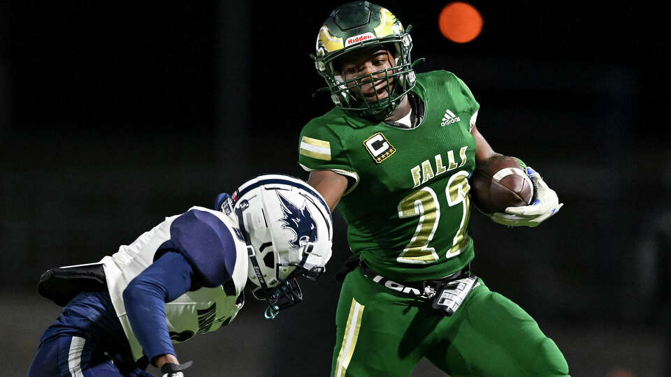 Cypress Falls running back Trey Morris (22) stiff arms Tomball Memorial linebacker Nyle Hughes (9) in the third quarter during the Region II-6A Division II bi-district game at Ken Pridgeon Stadium in Houston, Friday, Nov. 11, 2022.