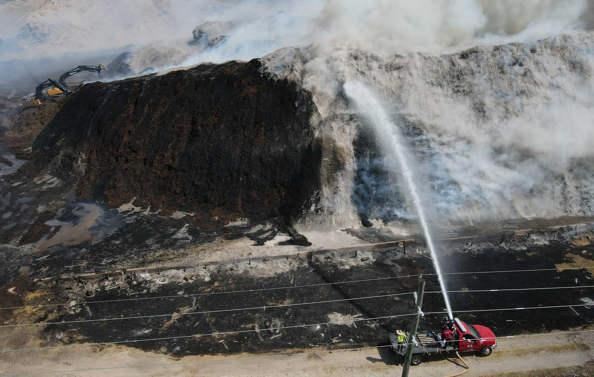 Large mulch fire burning for days likely caused by spontaneous