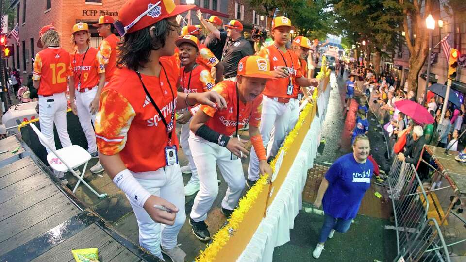 The Southwest Region champion Little League team from Needville, Texas, rides in the Little League Grand Slam Parade in downtown Williamsport, Pa., Monday, Aug. 14, 2023. The Little League World Series baseball tournament, featuring 20 teams from around the world, starts Wednesday, Aug 16, in South Williamsport, Pa. (AP Photo/Gene J. Puskar)