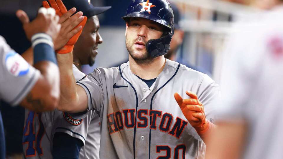 MIAMI, FLORIDA - AUGUST 15: Chas McCormick #20 of the Houston Astros celebrates with teammates in the dugout after hitting a home run against the Miami Marlins during the sixth inning at loanDepot park on August 15, 2023 in Miami, Florida.