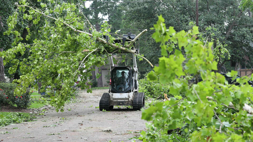 Crews clear debris after a storm brought heavy winds through the Cape Malibu subdivision, May 24, 2023, in Willis. The National Weather Service posted a tornado warning that week for several areas north of Houston.