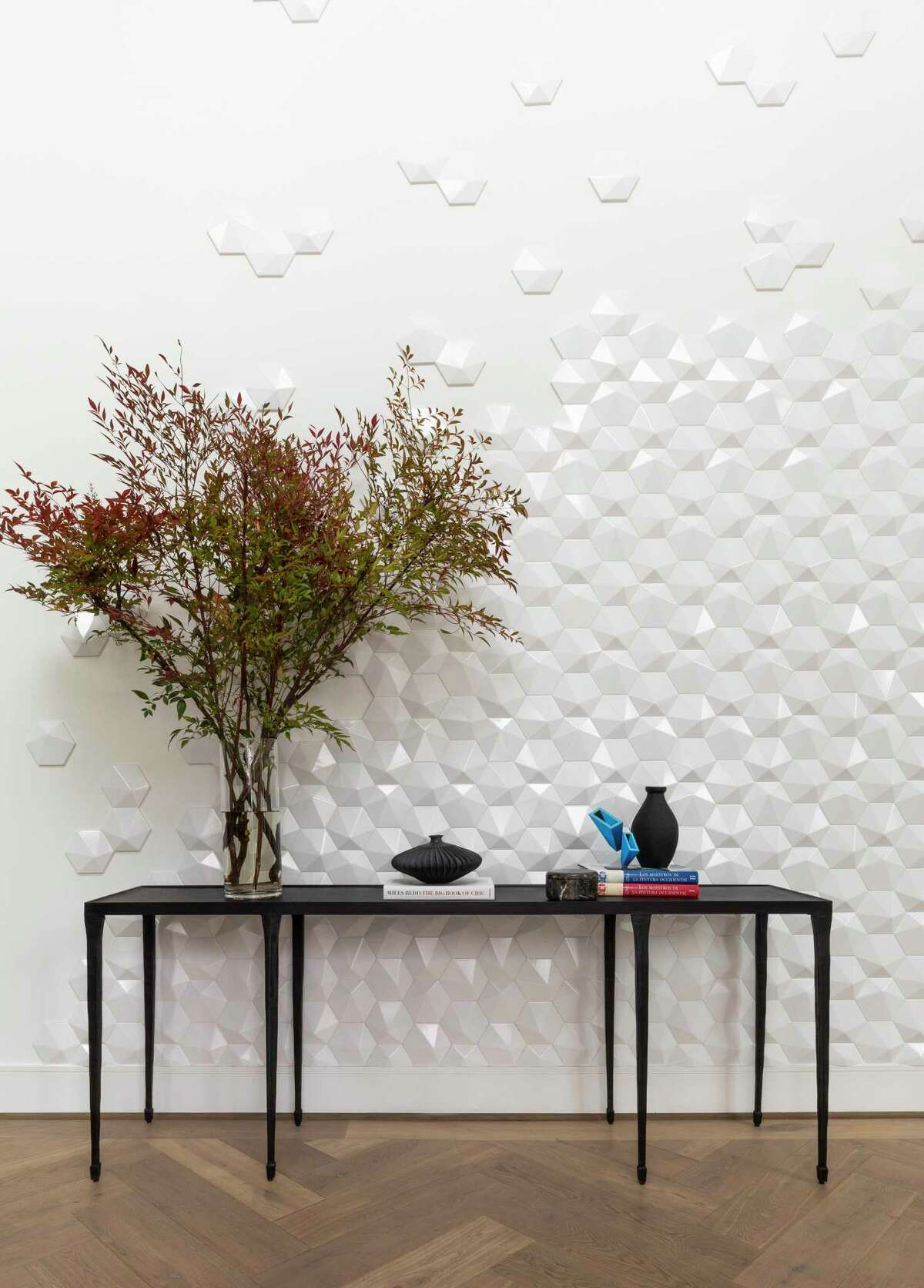 Three-dimensional tile runs up part of the wall in the foyer.