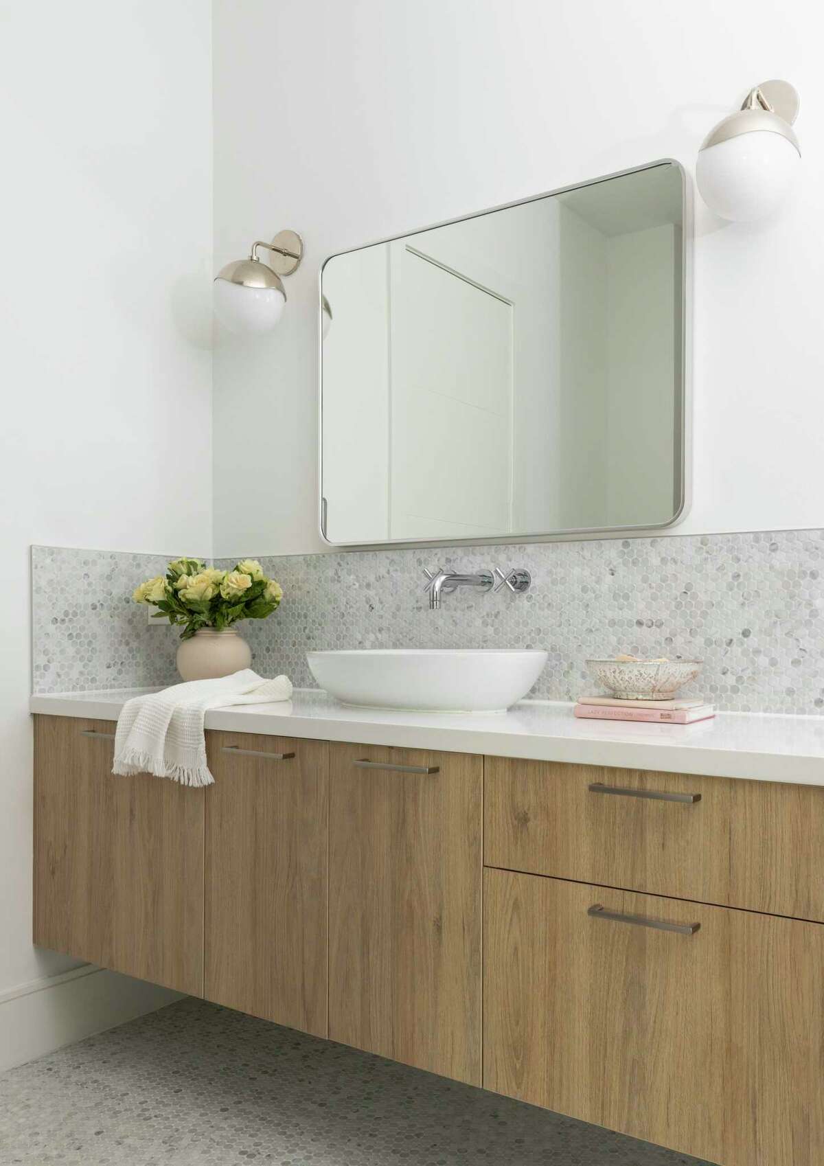Their daughter's bathroom has penny round marble tile on the floor and backsplash.