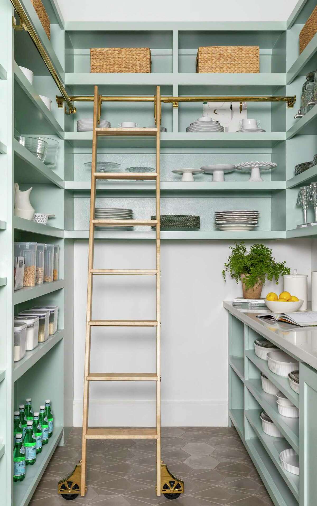 Green paint adds bright personality to the kitchen pantry.
