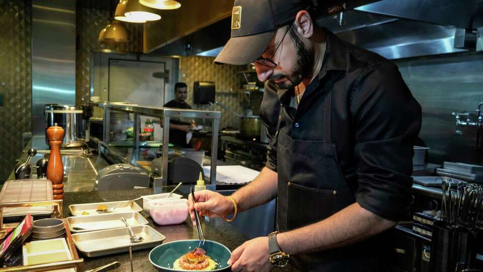 Chef Jassi Bindra plates tuna tartare in the kitchen at Amrina on Wednesday, Aug. 16, 2023 in The Woodlands. Bindra was featured in a recent episode of Chopped, in which he won.