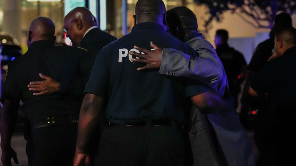 Law enforcement officers comfort each other outside of the emergency room at Memorial Hermann - Texas Medical Center after a Harris County sheriff's deputy was brought to the hospital on Wednesday, Aug. 16, 2023, in Houston. A Harris County sheriff's deputy was flown to the hospital after being shot during a traffic stop Wednesday night in north Harris County, authorities said.