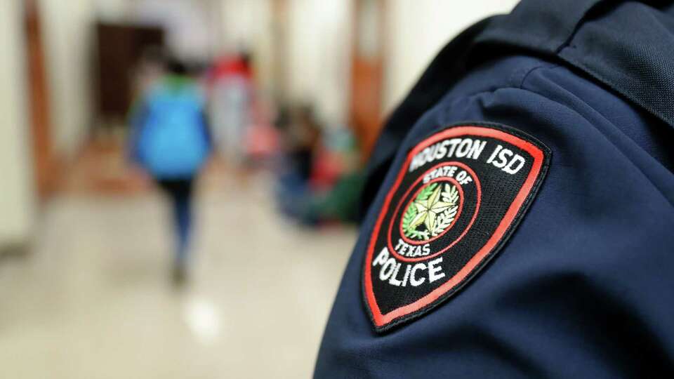 The shoulder patch of school resource officer Gilbert Vasquez as he greets students in the hallways before the start of classes at Pilgrim Academy, a K through 8th grade school, Thursday, Sept. 8, 2022 in Houston, TX.