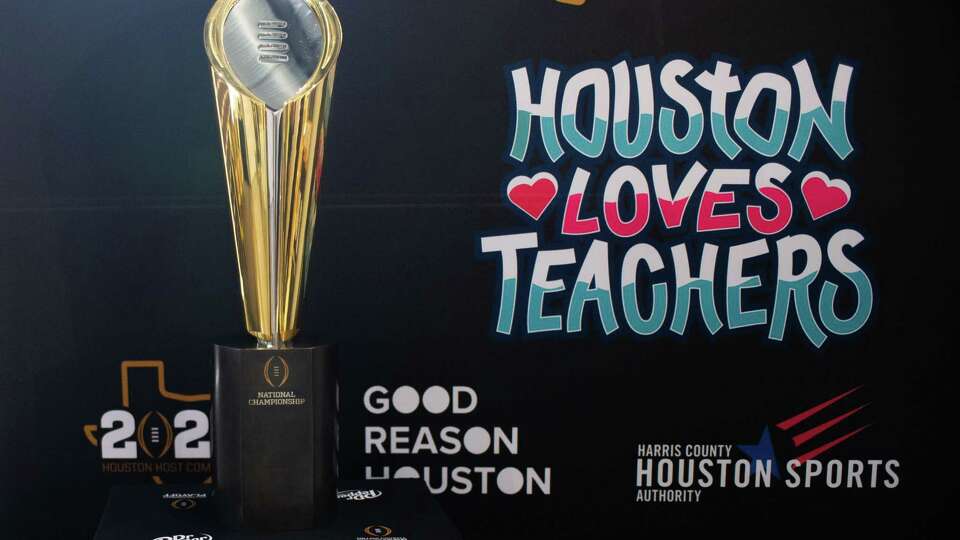 The 2024 College Football Playoff National Championship Trophy is on display at a press conference, Thursday, Aug. 17 at Milby High School, promoting the College Football Playoff National Championship to be played in Houston in 2024