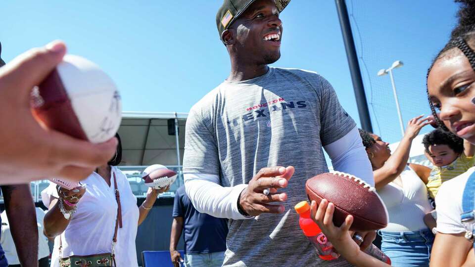 Houston Texans head coach DeMeco Ryans signs autographs after practice during an NFL training camp Thursday, Aug. 17, 2023, in Houston.