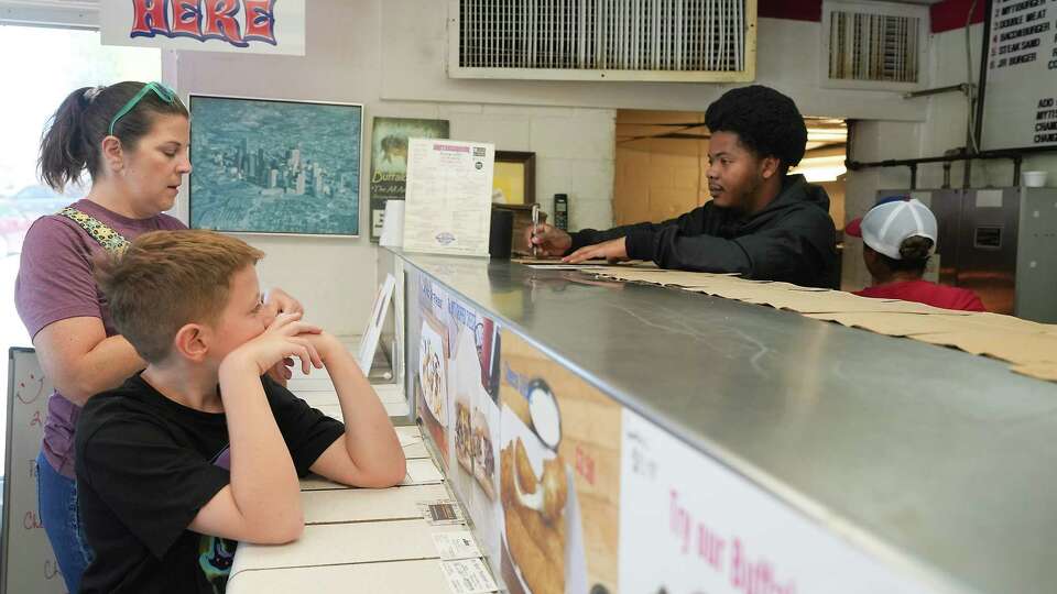 Customers place their order at Myti Burger, a diner in Garden Oaks, following a Facebook plea from its owner on Thursday, Aug. 17, 2023 in Houston.