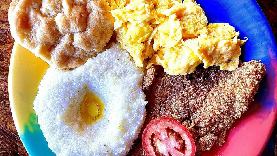 Catfish and grits with egg and biscuit breakfast plate at The Breakfast Klub, 3711 Travis St. The popular spot is listed as one of the top 100 places to eat in Texas by Yelp.