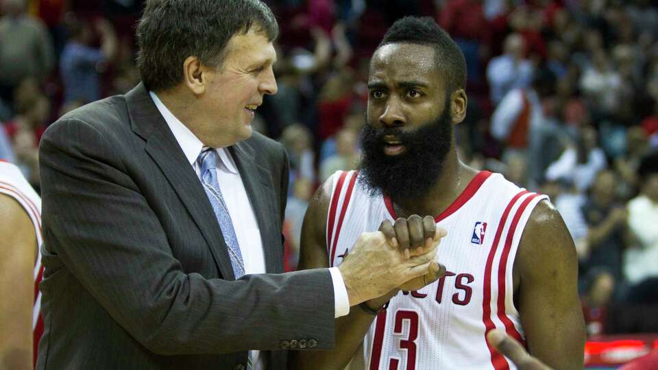 Houston Rockets head coach Kevin McHale, left, celebrates the Rockets 104-98 win over the San Antonio Spurs with Rockets guard James Harden (13) during the second half of an NBA basketball game at Toyota Center Monday, April 14, 2014, in Houston.