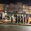 Firemen on the scene at a downtown fire Thursday night