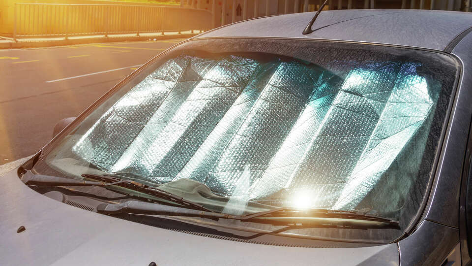 Protective reflective surface under the windshield of the passenger car parked on a hot day. Windshield reflectors are one of the best ways to keep spaces cool. 