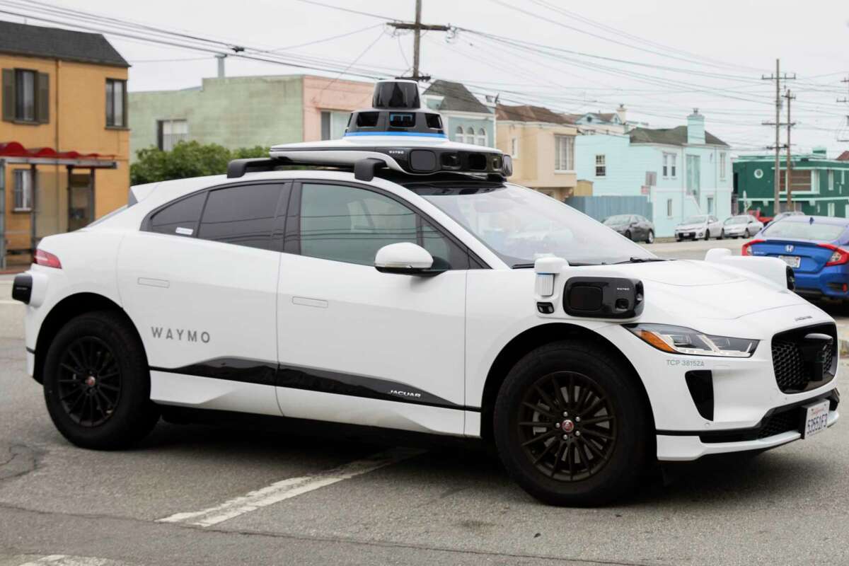 A Waymo robot taxi arrives at 27th Street and Noriega Street during a demonstration ride in San Francisco's Sunset District on August 25. 