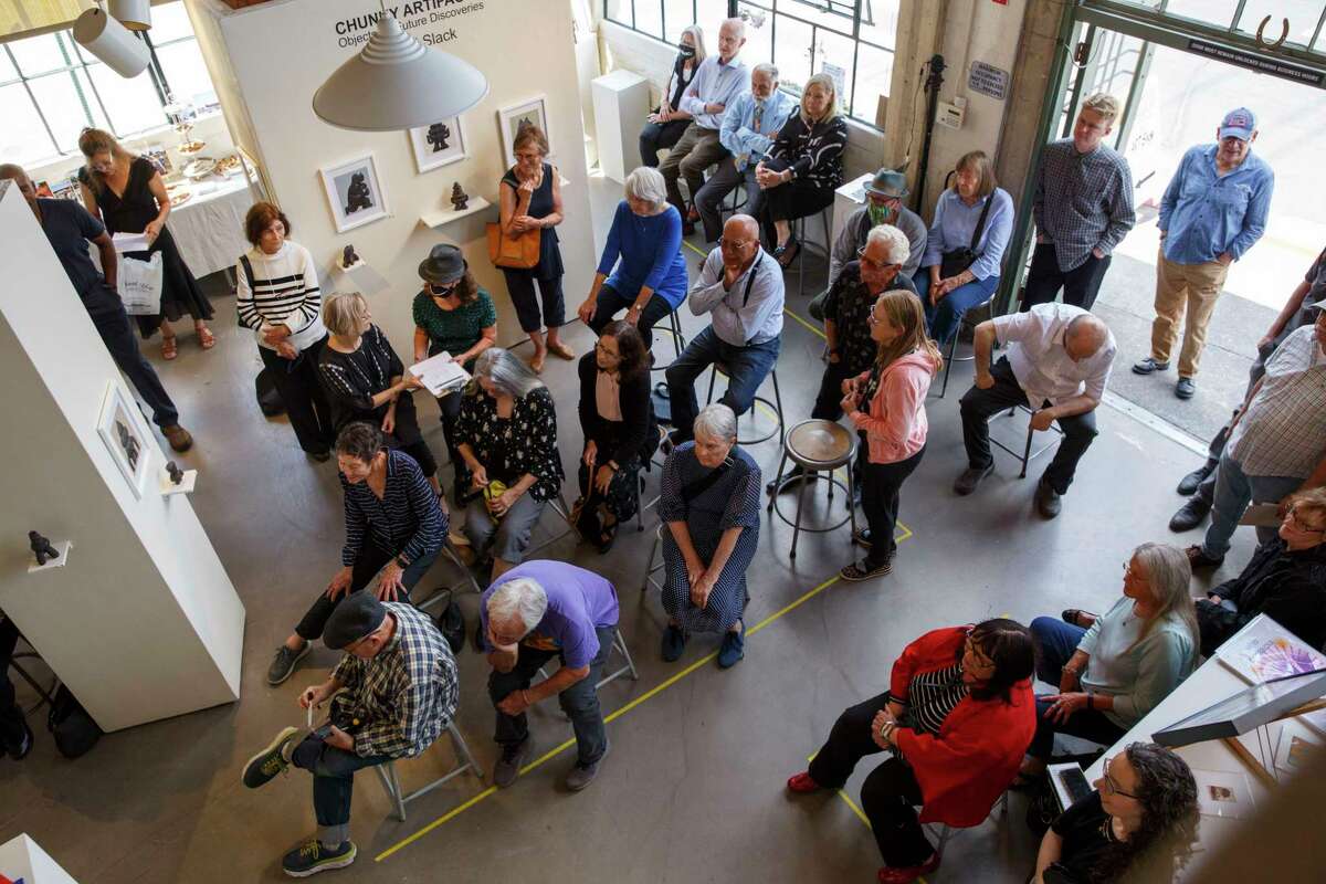 Friends and family members attend a memorial service for artist Tyler James Hoare.