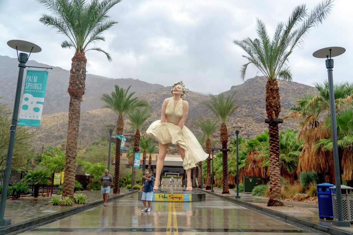Brian Pugh of Phoenix and Russ Cohen of San Francisco took a photo together before the arrival of Hurricane Hilary in Palm Springs on Sunday. Flash flood and high-wind warnings remained in effect until Monday morning.