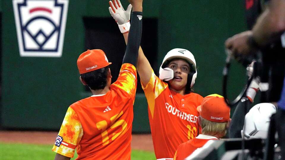 Needville, Texas' DJ Jablonski (10) celebrates with Jayson Arispe (15) after hitting a solo home run during the fourth inning of a baseball game against El Segundo, Calif., at the Little League World Series in South Williamsport, Pa., Monday, Aug. 21, 2021. (AP Photo/Gene J. Puskar)