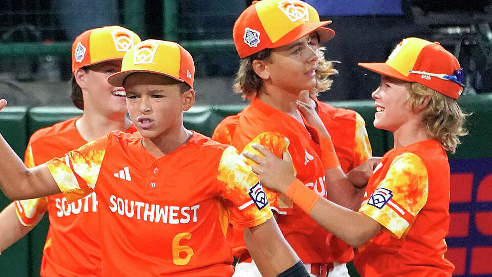 Needville, Texas' Jagger McRae, right, celebrates with DJ Jablonski, center right, after their win over El Segundo, Calif., in a baseball game at the Little League World Series tournament in South Williamsport, Pa., Monday, Aug. 21, 2023. (AP Photo/Tom E. Puskar)