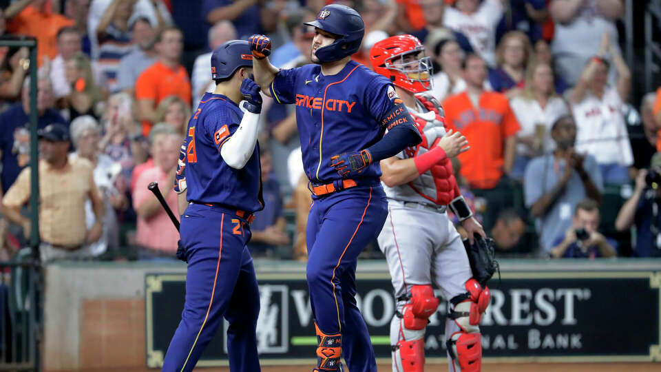 Houston Astros' Yainer Diaz, left, and and Chas McCormick, center, celebrate at the plate near Boston Red Sox catcher Reese McGuire, right, after McCormick's three-run home run during the fourth inning of a baseball game Monday, Aug. 21, 2023, in Houston. (AP Photo/Michael Wyke)