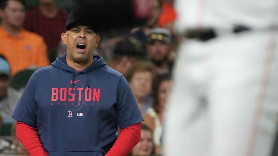 Boston Red Sox manager Alex Cora (13) shares his disapproval as Houston Astros starting pitcher Justin Verlander (35) swaps out an ear piece in the second inning at Minute Maid Park on Tuesday, Aug. 22, 2023 in Houston. Houston Astros won the game 7-3.