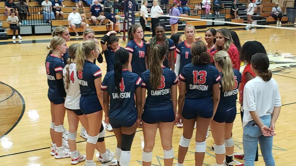 Dawson head coach Lauren Leth talks to her team during its four-set win over Clear Springs Tuesday night at Dawson High School.