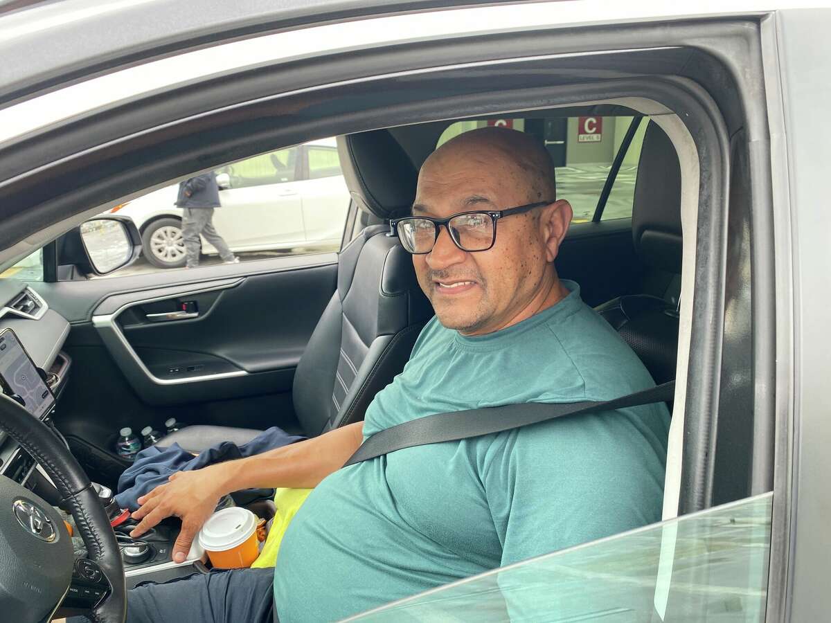 Esmeraldo Santos, an Uber driver for 10 years, waits to pick up passengers at SFO on August 21.