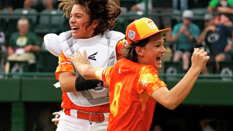 Needville, Texas, catcher DJ Jablonski, left, and starting pitcher Easton Benge (8) celebrate after getting the final out in the bottom of the ninth inning to win a baseball game against Seattle at the Little League World Series in South Williamsport, Pa., Wednesday, Aug. 23, 2023. (AP Photo/Gene J. Puskar)