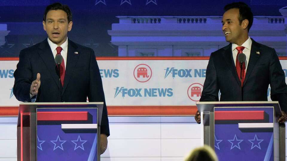 FILE - Florida Gov. Ron DeSantis speaks as businessman Vivek Ramaswamy listens during a Republican presidential primary debate hosted by FOX News Channel, Wednesday, Aug. 23, 2023, in Milwaukee. (AP Photo/Morry Gash, File)