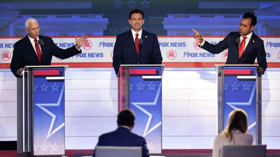 Republican presidential candidates, from left to right, former U.S. Vice President Mike Pence, Florida Gov. Ron DeSantis and Vivek Ramaswamy participate in the first debate of the GOP primary season hosted by FOX News at the Fiserv Forum on Aug. 23, 2023, in Milwaukee, Wisconsin.