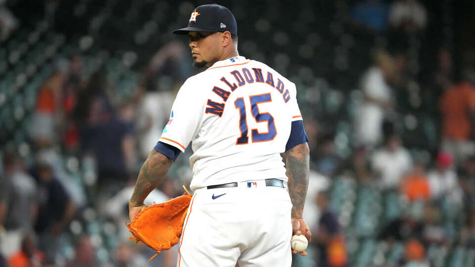 Houston Astros catcher Martin Maldonado (15) pitches in relief during the ninth inning of an MLB baseball game at Minute Maid Park on Thursday, Aug. 24, 2023 in Houston .