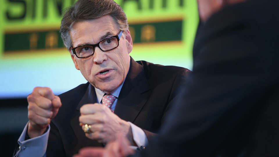 Former Texas Governor Rick Perry fields questions from Bruce Rastetter at the Iowa Ag Summit on March 7, 2015, in Des Moines, Iowa. He has now become a spokesman for Sports Betting Alliance. (Scott Olson/Getty Images/TNS)