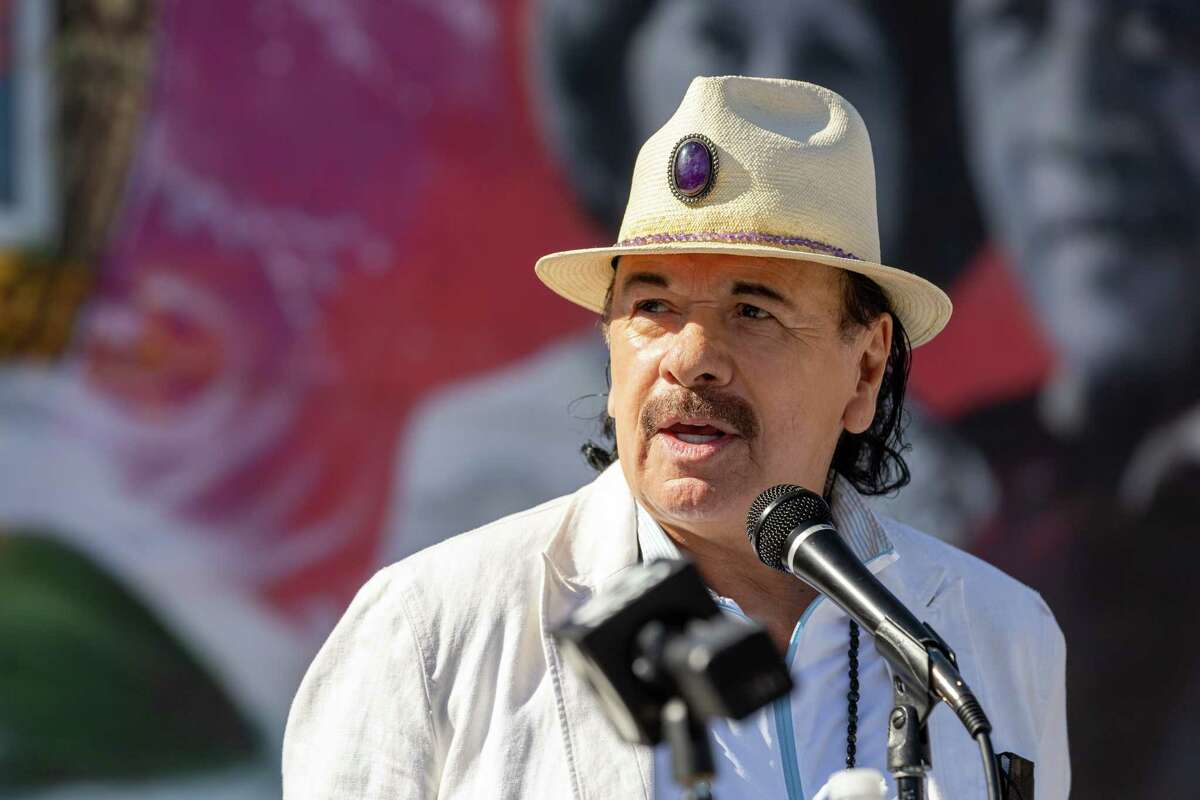 Grammy Award-winning guitarist Carlos Santana speaks during a mural dedication and blessing ceremony in honor of the Santana family at 24th Street Mission BART Station on Oct. 29, 2021. Santana grew up in San Francisco’s Mission District and went to Mission High School.