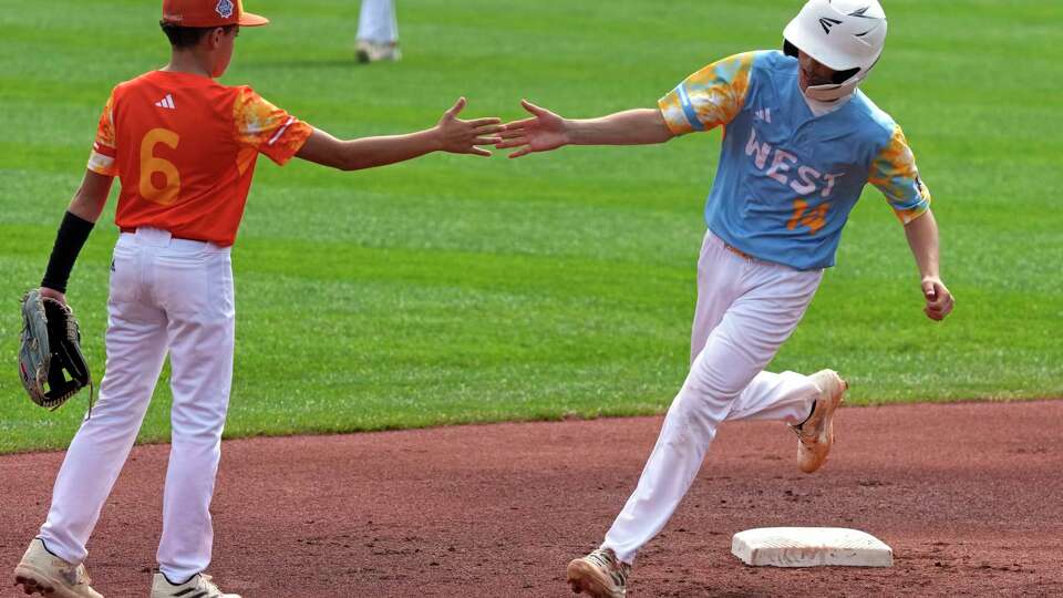 El Segundo, Calif.'s Brody Brooks (14) is greeted by Needville, Texas' Dayln Martin (6) as he rounds second base after hitting a solo home run during the first inning of the United States Championship baseball game at the Little League World Series tournament in South Williamsport, Pa., Saturday, Aug. 26, 2023. (AP Photo/Gene J. Puskar)