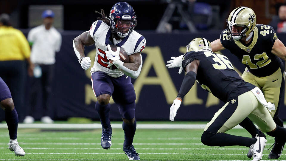 Houston Texans running back Mike Boone (22) runs the ball past New Orleans Saints cornerback Anthony Johnson (36) during an NFL preseason football game, Sunday, Aug. 27, 2023, in New Orleans. (AP Photo/Tyler Kaufman)