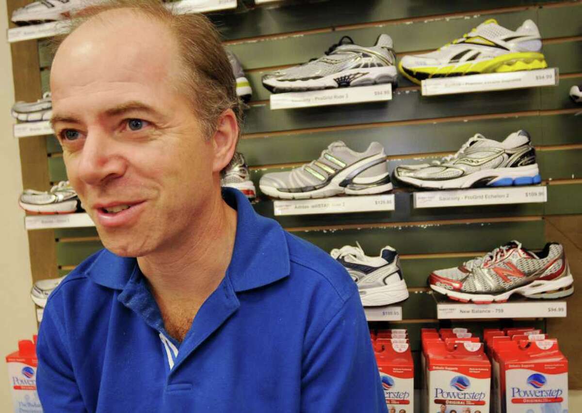 Bill Douglas discusses the fit of one of the shoes at Fleet Feet in Colonie on Wednesday, Oct. 18, 2010. (Luanne M. Ferris / Times Union)
