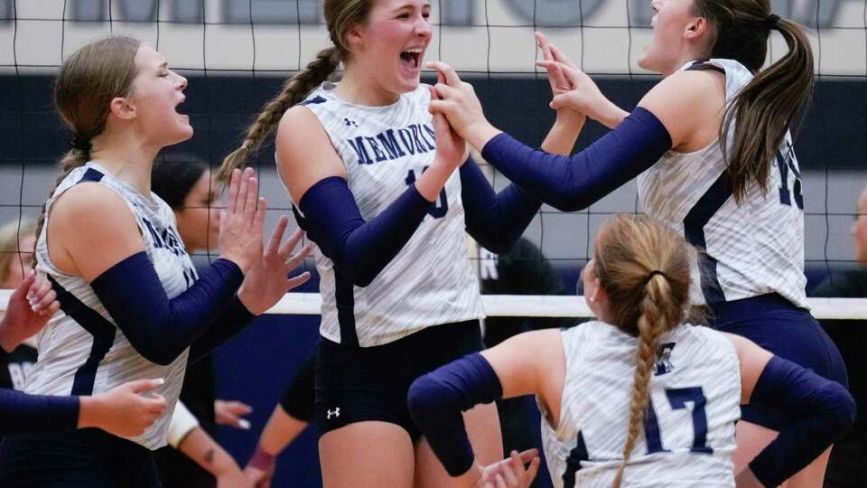 Tomball Memorial outside hitter Avery Craig (14) celebrates with setter Brooke Oliver (16) after scoring a point in the fourth set of a non-district high school volleyball match at Tomball Memorial High School, Tuesday, Aug. 29, 2023, in Tomball.