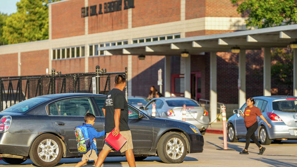 Children get dropped off for school on Wednesday, Aug. 30, 2023, at Cook Elementary School in Houston.