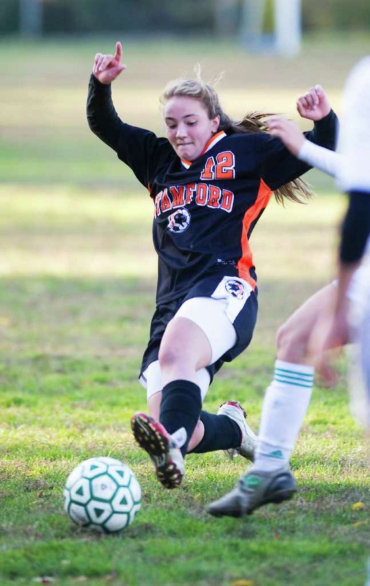 Stamford High School's Angela Altamura reaches for the ball against Trinity Catholic High School in girls soccer at Trinity in Stamford, Conn. on Friday October 22, 2010.